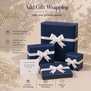 May include: Three navy blue gift boxes of varying sizes, each wrapped in textured paper and adorned with a white satin ribbon bow. A white rectangular gift note is placed in the foreground with the printed text: Happy Birthday Rachael! Hope you have the most amazing day. Enjoy your special gift! Love, Sarah.
