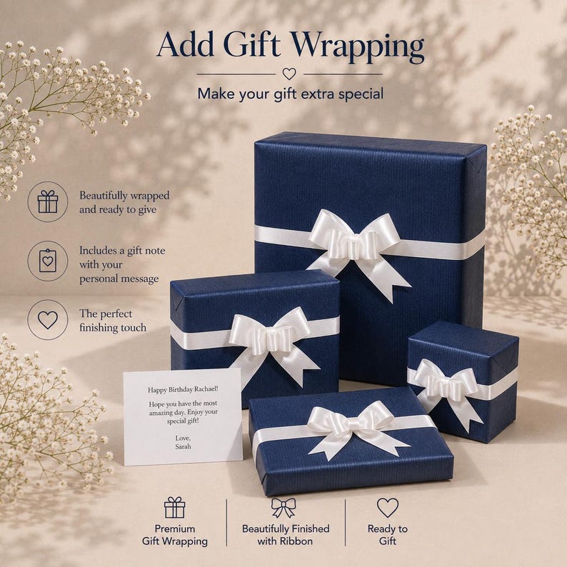 May include: Three navy blue gift boxes of varying sizes, each wrapped in textured paper and adorned with a white satin ribbon bow. A white rectangular gift note is placed in the foreground with the printed text: Happy Birthday Rachael! Hope you have the most amazing day. Enjoy your special gift! Love, Sarah.