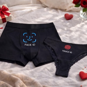 May include: A pair of black underwear consisting of boxer briefs and a lace-trimmed bikini brief. The boxer briefs feature a blue Face ID graphic and text, while the bikini brief displays a red fingerprint graphic and the text TOUCH ID.