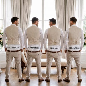 May include: Four individuals wearing white long-sleeved shirts, beige vests, and beige trousers. Each person wears white underwear visible above the waistband of their trousers, with the text GROOMSMAN printed on three and BEST MAN on one.