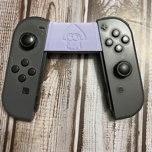 May include: A black Nintendo Switch Joy-Con controller with a purple 3D printed grip featuring a squid design.