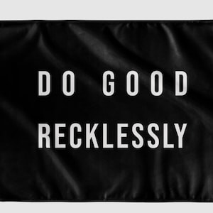 May include: Black flag with white text that reads "DO GOOD RECKLESSLY".