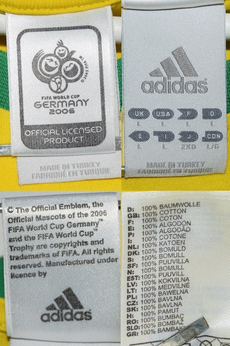 May include: A yellow soccer jersey with the FIFA World Cup Germany 2006 logo and the Adidas logo. The jersey has a white tag with the text "Official Licensed Product" and a white tag with size information in multiple languages. The jersey also has a white tag with the text "The Official Emblem, the Official Mascots of the 2006 FIFA World Cup Germany" and the text "FIFA World Cup Trophy are copyrights and trademarks of FIFA. All rights reserved. Manufactured under licence by Adidas."