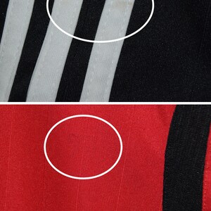 May include: Close-up of black and white striped fabric with a white stripe in the center. The fabric is smooth and has a slight sheen. Below the fabric is a close-up of red fabric with a black stripe on the right side. The fabric is smooth and has a slight sheen.