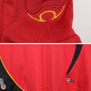 May include: Red soccer jersey with black and yellow accents. The jersey has a black and yellow logo on the sleeve and the text "climacool" on the side.