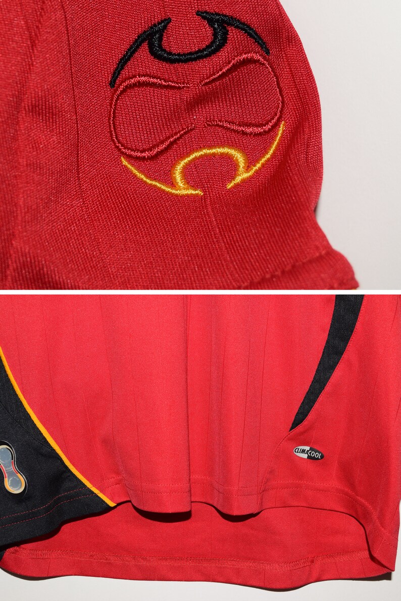 May include: Red soccer jersey with black and yellow accents. The jersey has a black and yellow logo on the sleeve and the text "climacool" on the side.