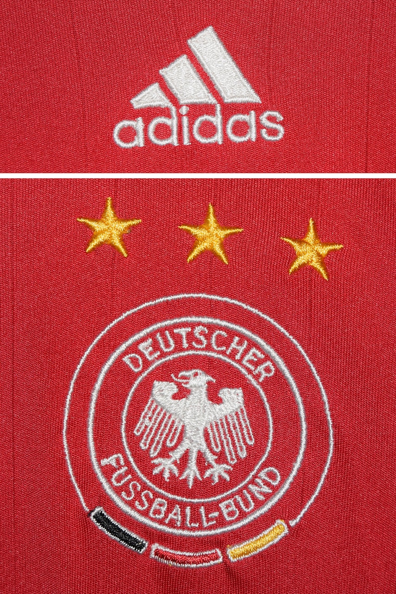 May include: Red soccer jersey with the Adidas logo, three gold stars, and the German national team crest, which reads "Deutscher Fussball-Bund".
