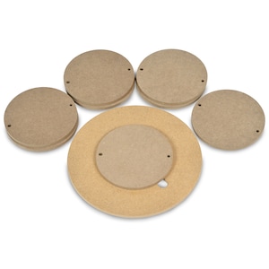 May include: A collection of unfinished wooden craft circles and a larger circular base. The pieces are various sizes and thicknesses, with small holes for assembly. The wood has a natural, light brown color.