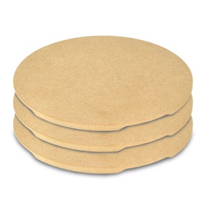 May include: Three round, beige-colored pizza stones stacked on top of each other.