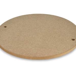 May include: A round, light brown wooden craft circle with two small holes drilled into the surface.
