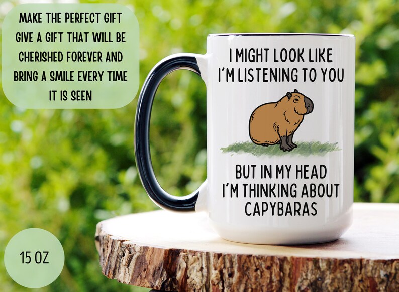 Peut inclure: Mug en c&eacute;ramique blanche avec une anse et un bord noirs, orn&eacute; d'une illustration de capybara et du texte "I might look like I'm listening to you, but in my head I'm thinking about capybaras." Le mug contient environ 444 ml.