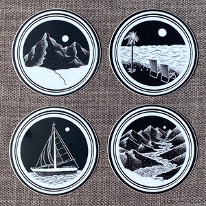 May include: Set of four black and white circular stickers with different nature scenes. Each sticker features a moon, a mountain range, a sailboat, a palm tree, and a river.