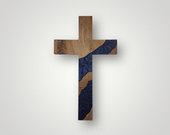 Può includere: Una croce di legno con un'intarsio in resina blu. La resina ha un effetto marmoreo ed è modellata come un fiume che scorre al centro della croce.