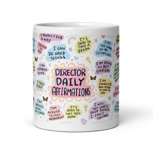 May include: White ceramic mug with colourful affirmations, including "Director Daily Affirmations." The mug features various phrases like "I can do hard things" and "I am energised." Butterflies and floral accents decorate the mug.