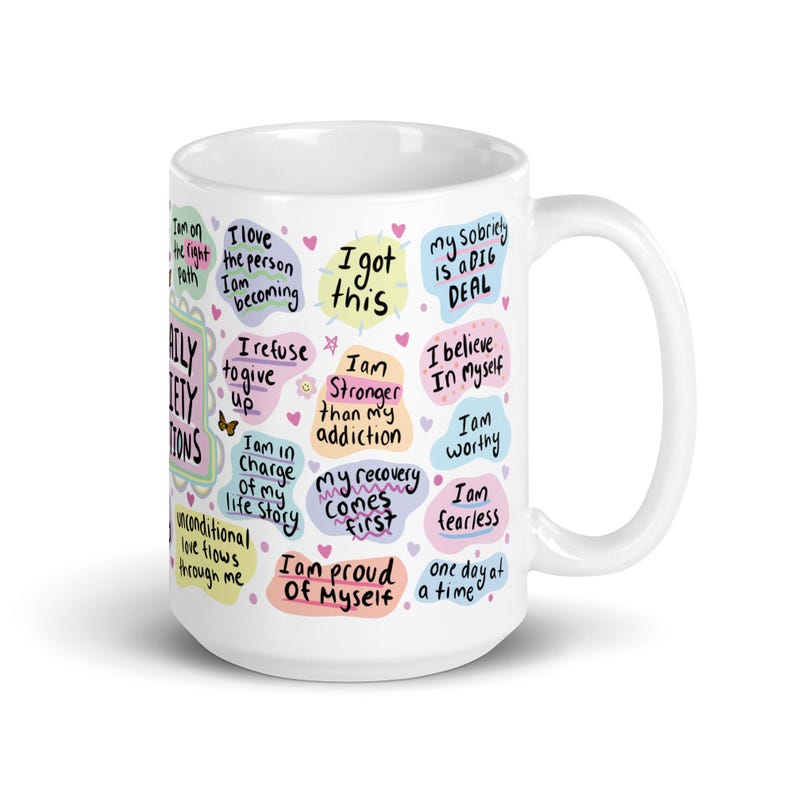 May include: White ceramic mug with colourful text in a speech bubble design. The text includes positive affirmations such as "I am stronger than my addiction", "I am worthy", "My recovery comes first", and "I am proud of myself".