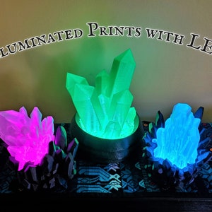 Three different lighted LED crystal lamps offer examples of custom 3D printed electronics projects that can be commissioned from the shop Nautolith Crafts. Text on the image reads "Illuminated Prints with LEDs".