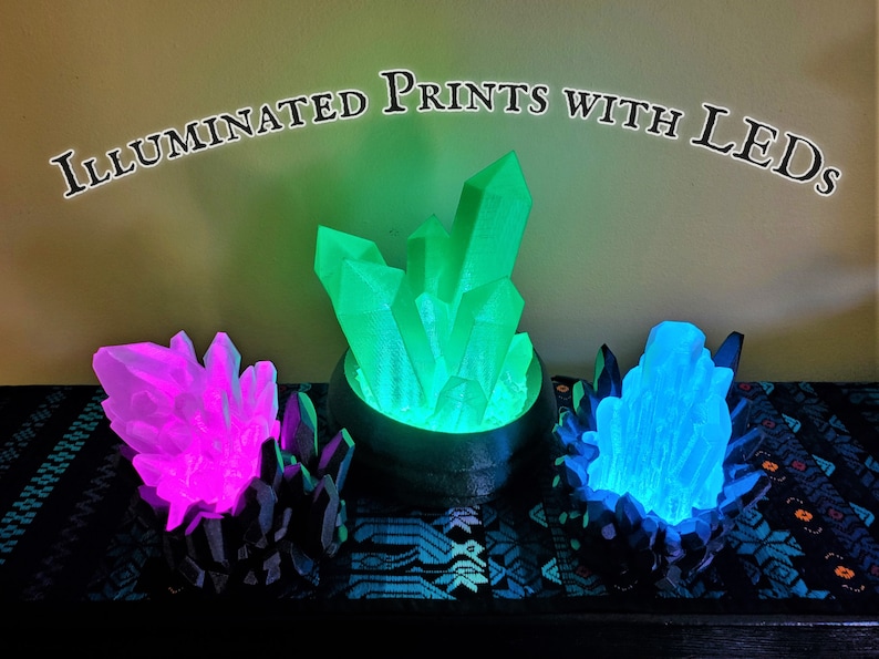 Three different lighted LED crystal lamps offer examples of custom 3D printed electronics projects that can be commissioned from the shop Nautolith Crafts. Text on the image reads "Illuminated Prints with LEDs".