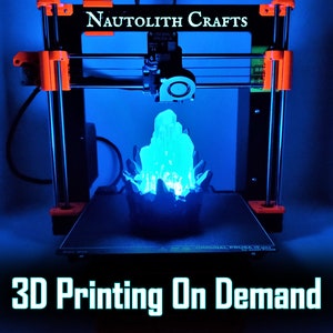 An illuminated 3D printed blue crystal LED lamp sits on the build plate of a 3D printer. The text "3D Printing on Demand" indicates that this listing offers personalize custom 3D printing services from the shop Nautolith Crafts.