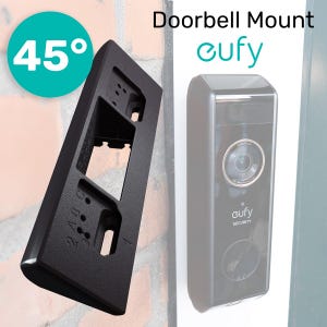 Może przedstawiać: Czarny uchwyt do dzwonka z kątem 45 stopni, przeznaczony do dzwonka eufy. Uchwyt ma prostokątny kształt z wieloma otworami i numerowanymi oznaczeniami. Dzwonek eufy jest czarny z obiektywem kamery i logo eufy security.