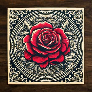 May include: A red rose with intricate details is surrounded by a black and white floral pattern within a decorative frame. The frame has a cream background and a black border.
