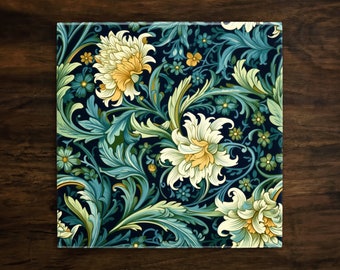 May include: A square tile with a floral pattern. The tile features a dark blue background with white and yellow flowers and green leaves.
