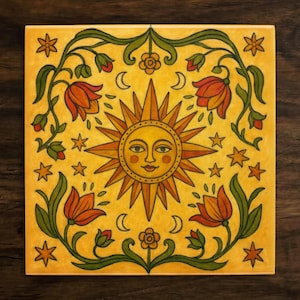 May include: A yellow ceramic tile with a hand-painted design of a sun with a smiling face surrounded by stylized flowers and stars. The tile has a yellow background with green, orange, and red accents.