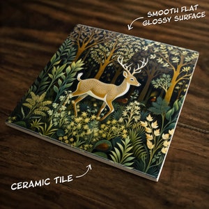 May include: A ceramic tile with a glossy surface features a detailed illustration of a deer standing in a lush forest. The forest is depicted with a variety of green and yellow foliage, creating a vibrant and intricate design.