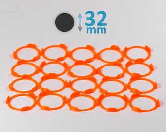 May include: Twenty-four orange plastic rings arranged in a grid pattern. The rings are 32 mm in diameter.