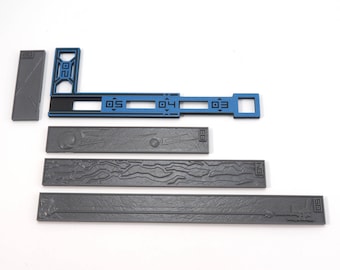May include: A set of five gray plastic pieces for a board game. The pieces are rectangular and have different textures. One piece has a blue section with the numbers 03, 04, and 05.