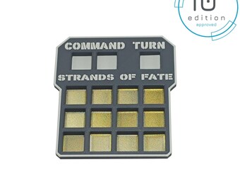 May include: A gray plastic game board with the text "Command Turn Strands of Fate" and 18 small squares. The board is labeled "10th edition approved".