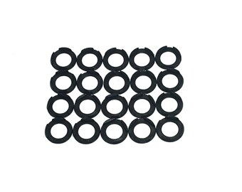 May include: A set of 20 black metal washers. The washers are arranged in a grid pattern.