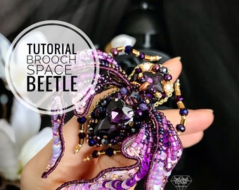 May include: A purple and gold beaded beetle brooch with iridescent sequins. The brooch is handmade and features a large purple crystal in the center. The text "TUTORIAL BROOCH SPACE BEETLE" is visible in the image.