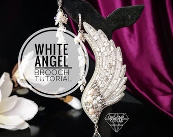 May include: White angel wing brooch tutorial. A silver and white beaded brooch with a crystal teardrop pendant. The brooch is shaped like an angel wing and is decorated with pearls and beads.