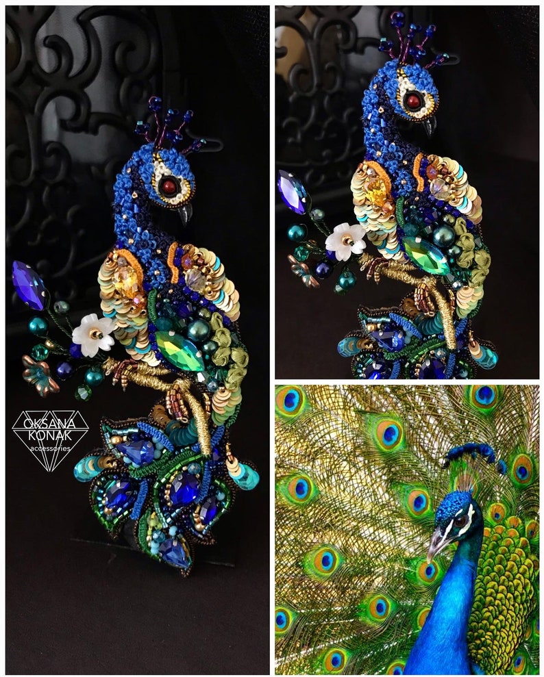 May include: A beaded peacock brooch with blue, green, and gold sequins. The peacock is perched on a branch with white flowers. The brooch is handmade and features intricate details.