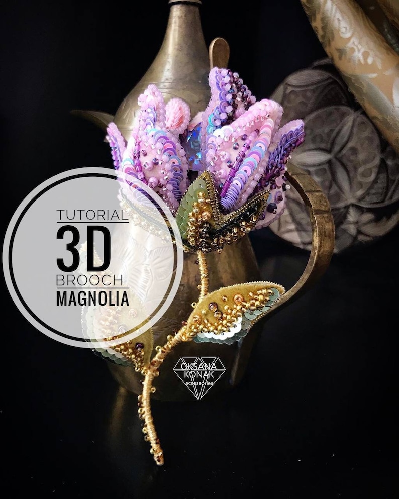 May include: A 3D beaded magnolia flower brooch with a gold stem and leaves. The brooch is made with pink, purple, and gold beads and sequins. The text "TUTORIAL 3D BROOCH MAGNOLIA" is on a white circle behind the brooch.