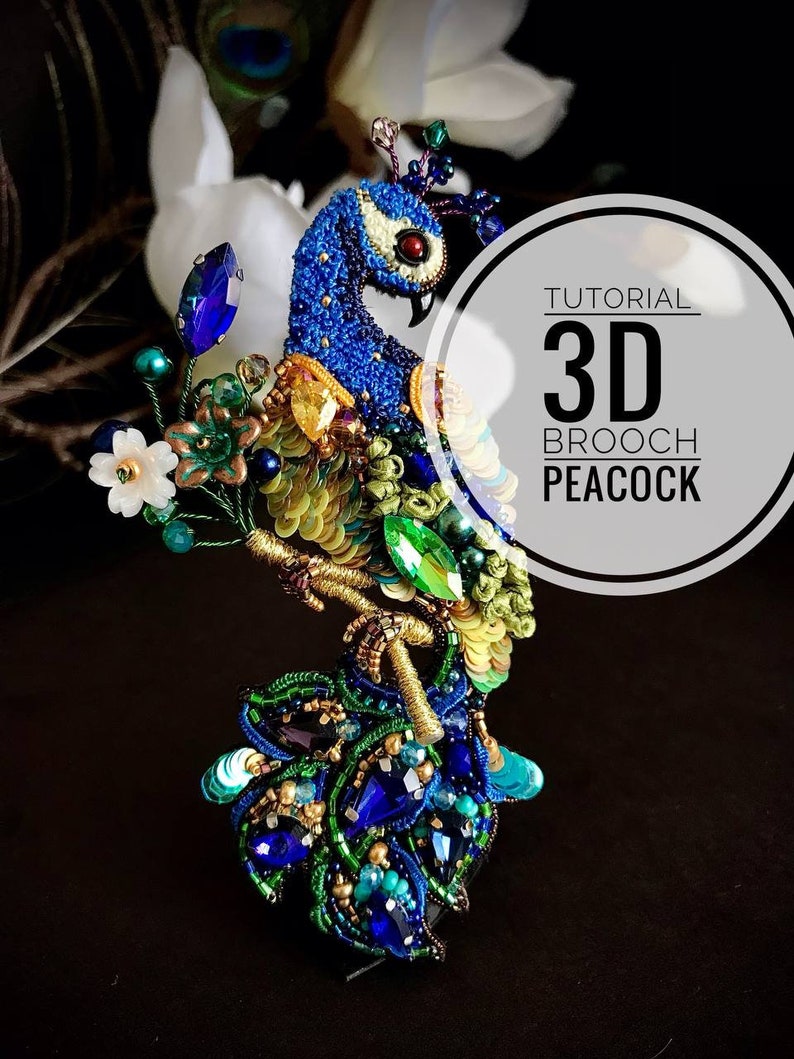 May include: A 3D beaded peacock brooch with a blue body, green and gold tail feathers, and a red eye. The brooch is on a black background with a white flower and a white feather.