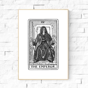 May include: Black and white illustration of a tarot card, The Emperor, featuring a figure in a hooded robe sitting on a throne. The card number, IV, is displayed in the top right corner. The text "THE EMPEROR." is printed below the image.