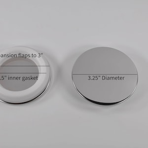 May include: Two round drain covers, one with a white rubber gasket and expansion flaps to 3 inches, and the other with a 3.25 inch diameter.
