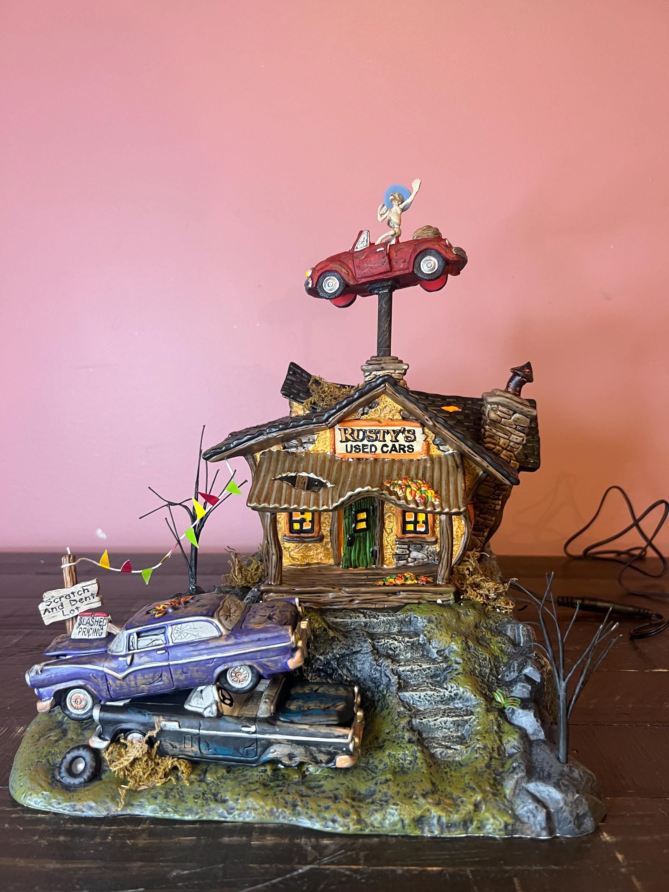 Dept 56: Rusty's Used Cars - Snow Village Halloween Series Dept 56: Rusty's Used Cars - Snow Village Halloween Series