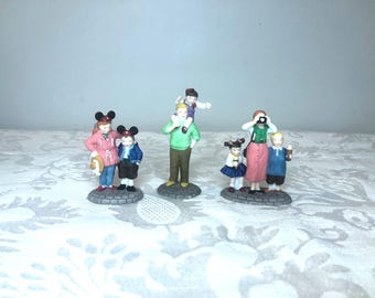 May include: Set of five miniature figurines depicting people in various poses. The figurines are made of painted ceramic and feature details like clothing, hats, and accessories.