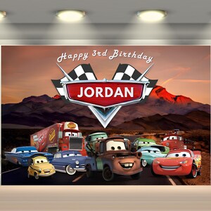 May include: A colorful birthday backdrop featuring characters from the animated movie Cars. The backdrop includes the text "Happy 3rd Birthday" and the name "Jordan" in a stylized logo, with a mountain landscape background.