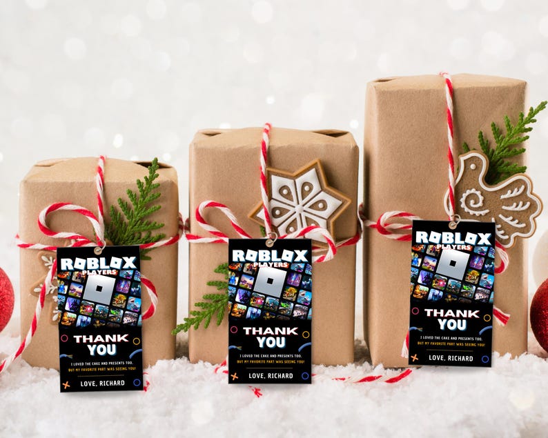 May include: Three brown gift boxes wrapped with red and white twine and decorated with a snowflake, a bird, and a small evergreen tree. Each box has a black gift tag with a Roblox logo and the text "Roblox Players Thank You I loved the cake and presents too but my favourite part was seeing you Love, Richard".