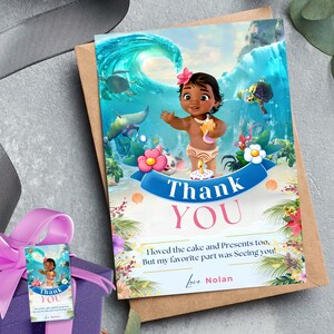 May include: A thank you card with a cartoon image of a girl with brown skin and dark hair wearing a flower crown and a lei. The card has a blue and green ocean background with a wave and a sea turtle. The text on the card reads "Thank You" in pink letters and "I loved the cake and presents too, But my favorite part was seeing you! Love Nolan".