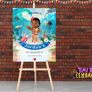 May include: A blue and green welcome sign with a cartoon character of Moana from the Disney movie Moana. The sign says "Welcome to Jordan's 1st Birthday Celebration".