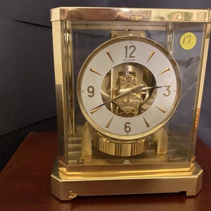 Jaeger LeCoultre; Atmos Mantle Clock circa 1960 with brass wall mount stand.