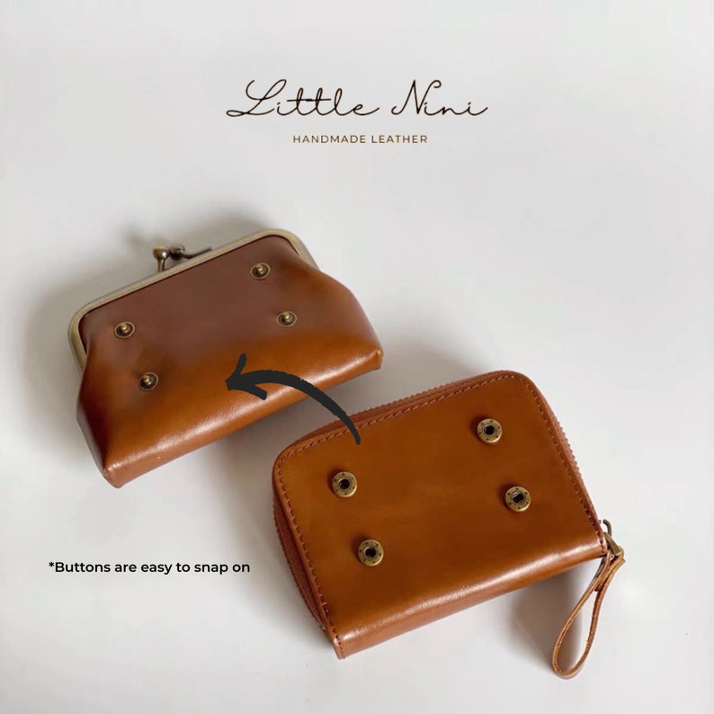 May include: Two brown leather wallets with metal snaps and rivets. The smaller wallet has a fold-over closure and the larger wallet has a zipper closure. "Buttons are easy to snap on" is written below the wallets.