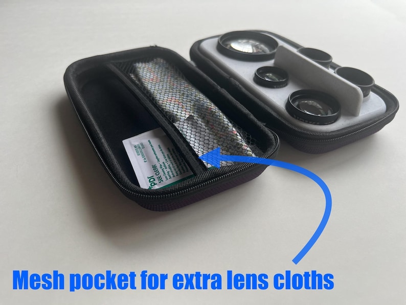 May include: Black zippered case with a mesh pocket containing lens cloths and a small packet. Next to it is a case with multiple camera lenses. The text "Mesh pocket for extra lens cloths" is visible.