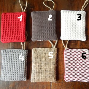 May include: Six different textured fabric swatches with numbers 1 through 6 written on them. The swatches are red, brown, white, gray, beige, and burgundy.