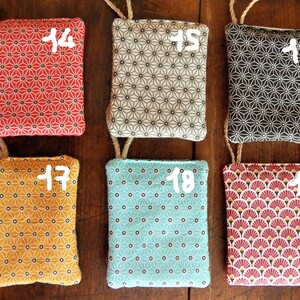 May include: Nine fabric swatches with different geometric patterns. The swatches are numbered 14 through 19. The swatches are in various colors, including red, black, white, yellow, blue, and pink.