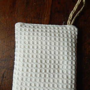 May include: White waffle weave cotton kitchen towel with a knotted loop handle.